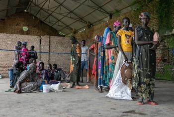 People wait in line at a food distribution site in Malakal, South Sudan.