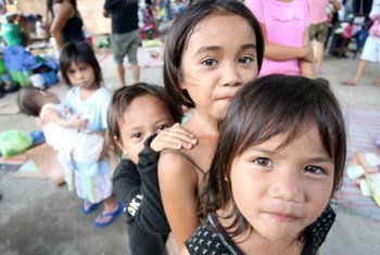 A group of children displaced by floods, following the passage of tropical storm Washi, living in an evacuation centre in Iligan City, Philippines