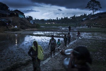 Rohingya refugees walk across the Balukhali settlement in Bangladesh's Cox Bazar district. Since August 2017, over 600,000 Rohingya refugees have arrived in Bangladesh, joining over 200,000 already displaced over the past decades.