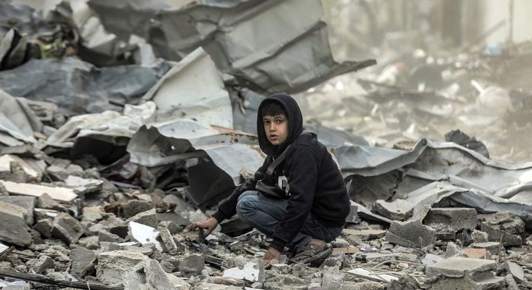 A boy sits amongst the destruction of the Al-Touam neighbourhood in the northern Gaza Strip.