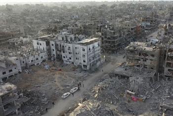 The Kamal Adwan hospital (left) in northern Gaza is surrounded by destruction.