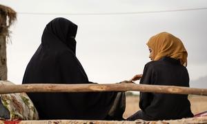 A woman and girl interact in rural in Yemen 