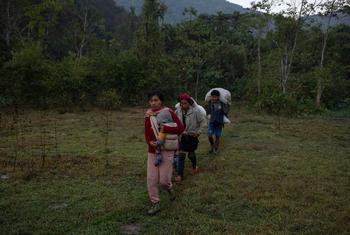 A family walks through Kayah State, in southeastern Myanmar, on their way to safety across the border to Thailand. 