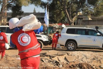 Syrian Arab Red Crescent (SARC) staffers carrying WFP aid for people stranded in besieged Old Homs City during a humanitarian pause in the fighting.